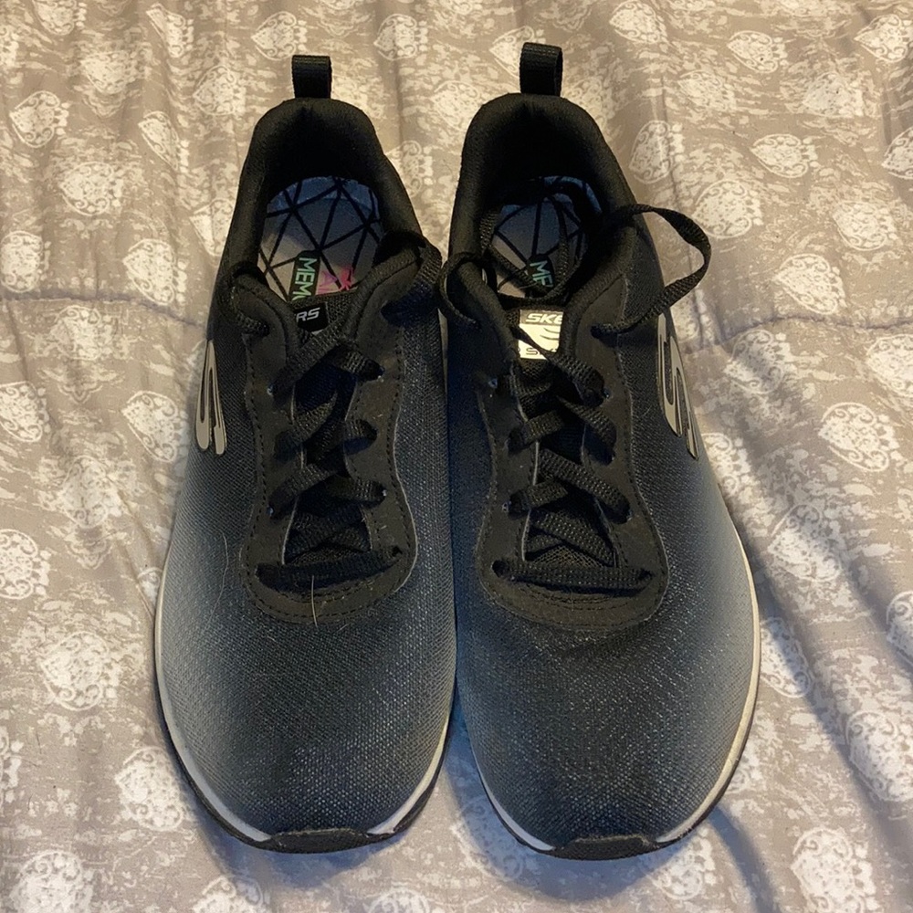 Black and grey Skechers.